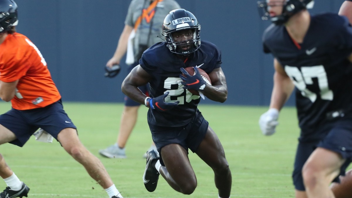 Freshman running back Xavier Brown carries the ball during Virginia football fall camp.